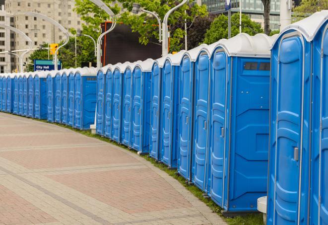 a row of portable restrooms set up for a large athletic event, allowing participants and spectators to easily take care of their needs in Beech Creek KY